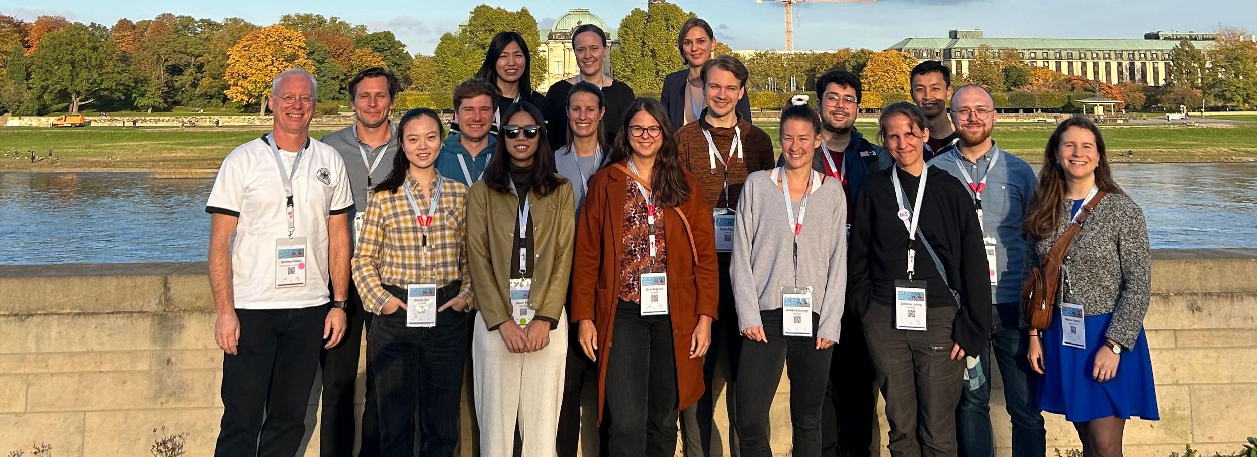 A group of people posing in front of a river at a scientific conference